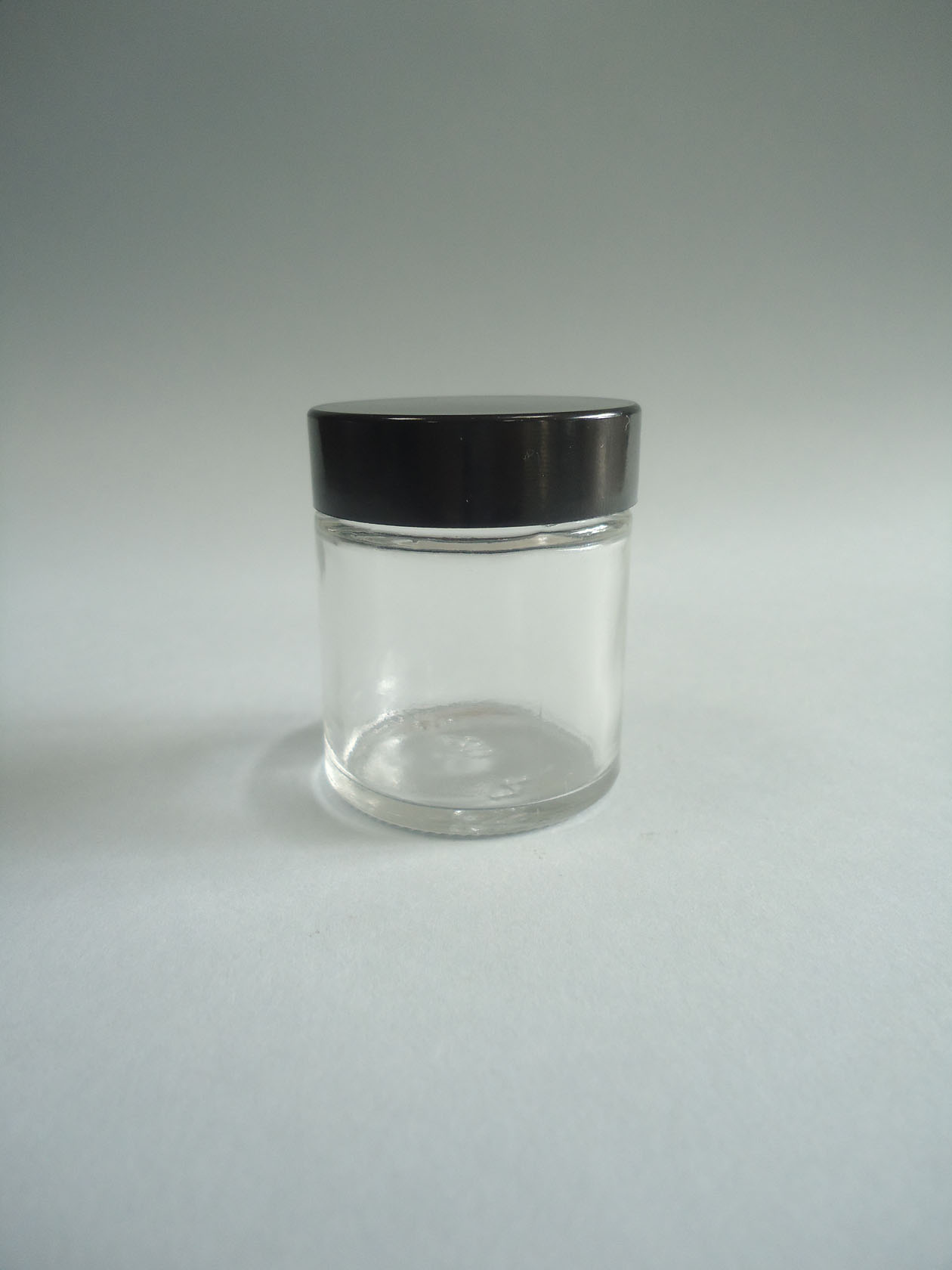 Bote vidrio tapa baquelita negra  30 ml. transparente